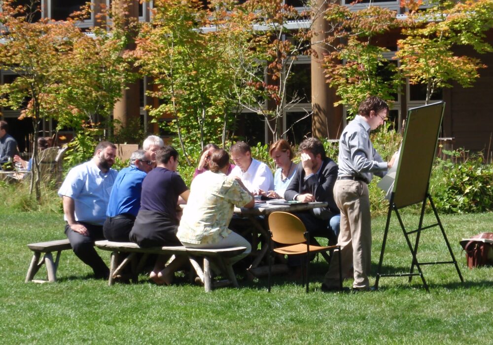 Sustainable Design Leaders breakout session outside at picnic table at Garrison Institute 2012