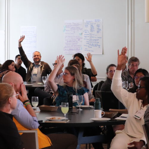 Classroom of Summit participants raising hands 2025 Super Summit