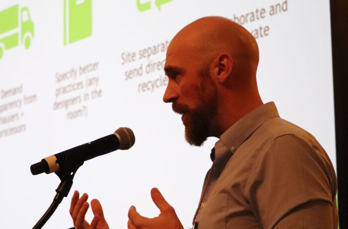 Man at podium with screen behind him during 2025 Super Summit