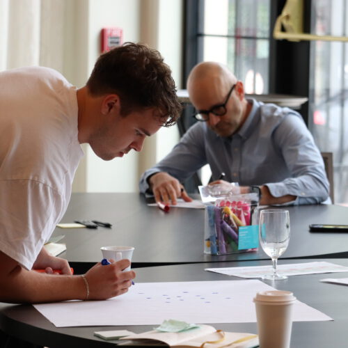 Two men engaged in breakout session at 2025 Super Summit
